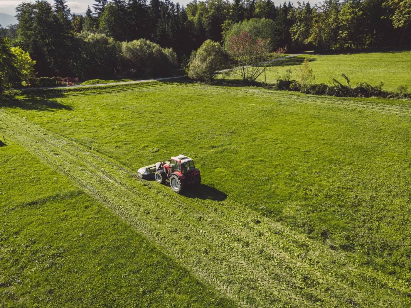 Letecký pohled na traktor sekoucí louku
